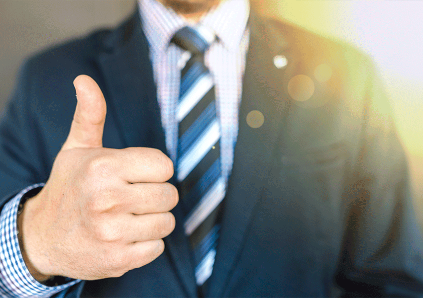 Un home amb vestit està donant el polze cap amunt.
