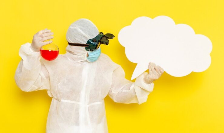 front-view-male-scientific-worker-special-protective-suit-holding-flask-with-red-solution-big-white-sign-yellow-desk_140725-64046.jpg